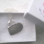 Heart fingerprint necklace made with an ink pint on paper