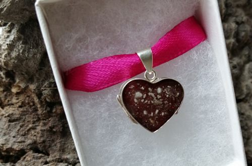Silver heart locket with cremation ashes